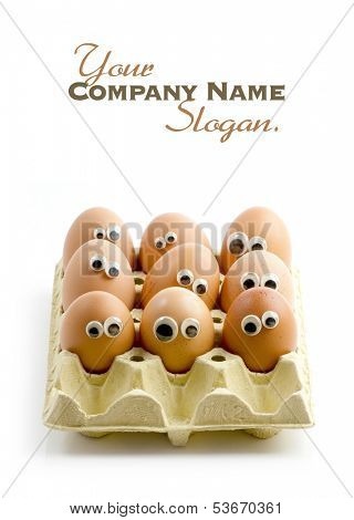 A group of eggs in a box with funny eyes 