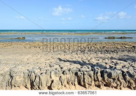A sunny beach with layers of water