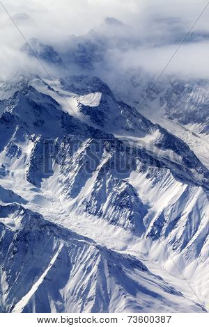 Top View On Snow Mountains And Glacier In Fog
