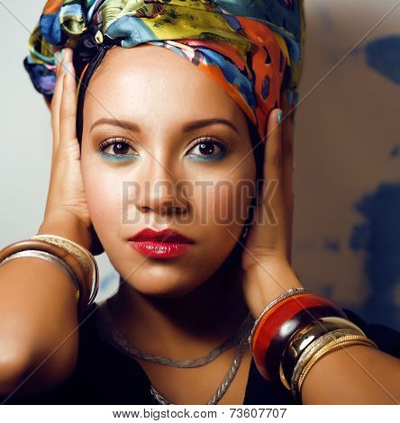beauty bright african woman with creative make up, shawl on head like cubian woman