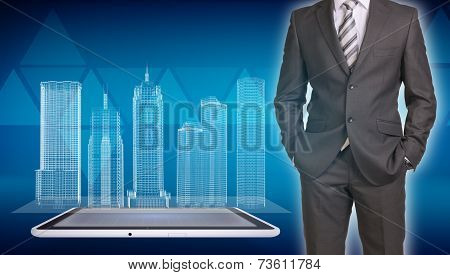 Businessman and wire-frame buildings on screen tablet pc