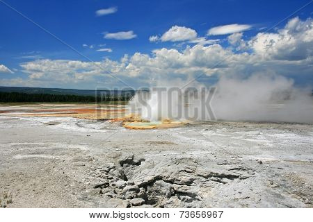 Geyser Basin Erupts Against Blue Sky