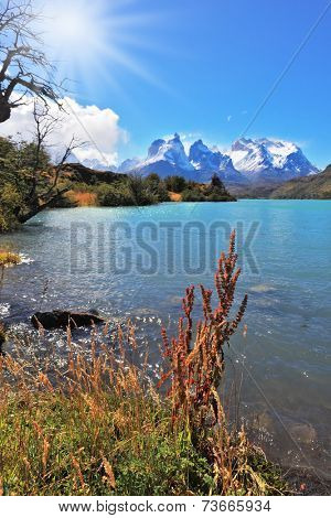 Majestic rocks Los Kuernos on the bank of the lake are covered with glaciers. Magic turquoise lake Pehoe national park Torres del Paine, Chile. 