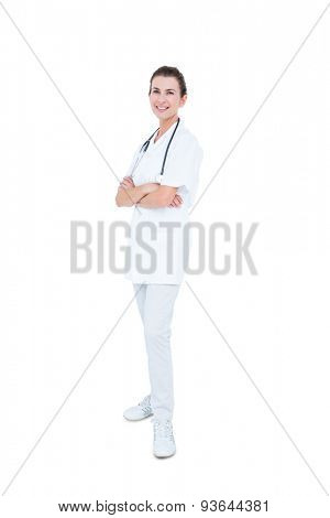 Female doctor folding arms against white background