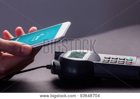 uploading screen against man using smartphone to express pay