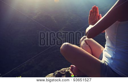 young yoga woman at sunrise mountain peak