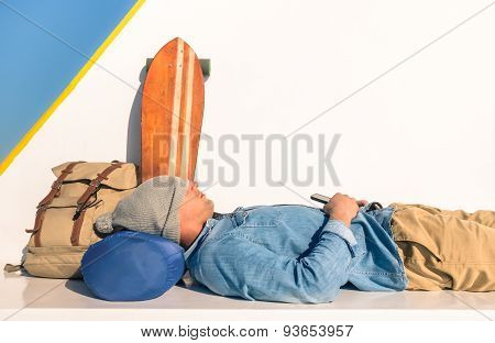 Young Hipster Man Having A Rest During A Ferry Boat Passage Holding His Smartphone  - Modern Concept