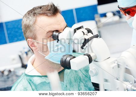 dentist male doctor working with microscope at dentistry office