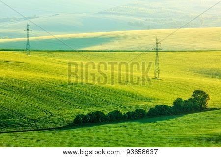 Moravian summer rolling landcsape with two power line tower. Moravia, Czech Republic