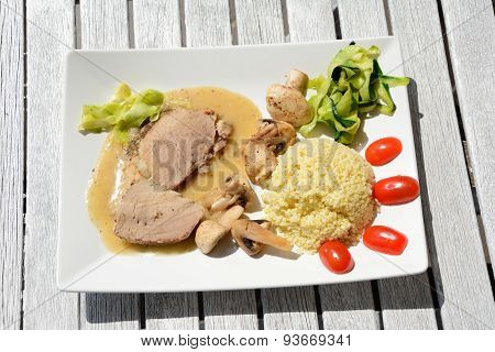 Baked Pork Loin, Millet Gruel, Mushrooms And Vegetables.