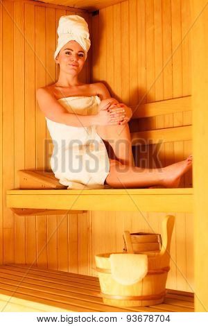 Woman Sitting Relaxed In Wooden Sauna