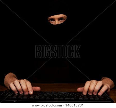 Dangerous hacker in black balaclava