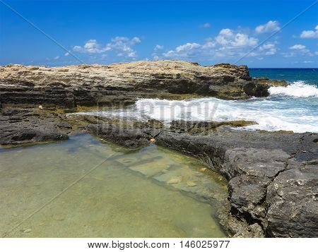 Big waves on rock coast blue sea and sky on Crete Greece