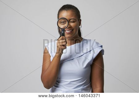Portrait Of Female Criminologist With Magnifying Glass