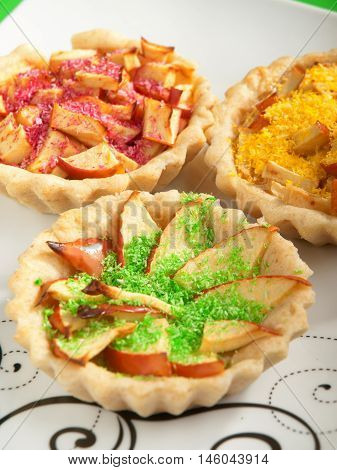 Small apple tartelettes with decoration. Vertical shot