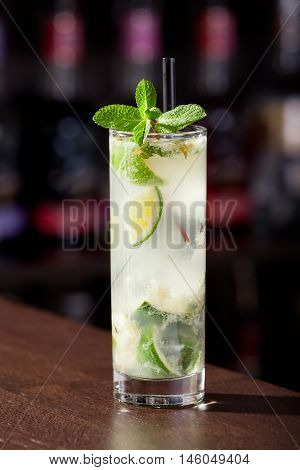Mojito cocktail on a bar counter in a nightclub.