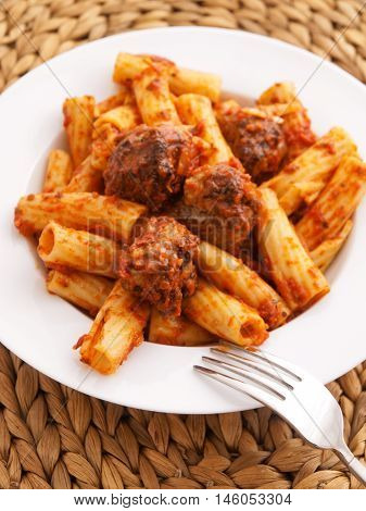 Itailian penne pasta with meatballs and tomatoes sauce