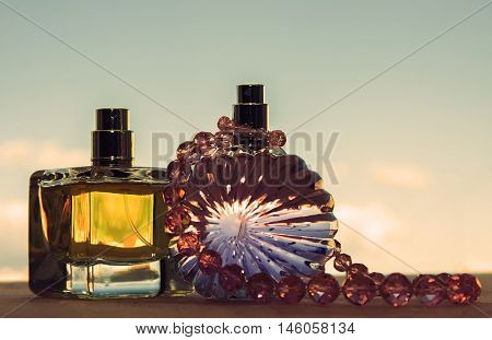 different bottle of perfume with pink pearls