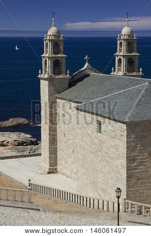 Spain Galicia Muxia Virxen de la Barca Sanctuary on Atlantic coast sail boat at sea