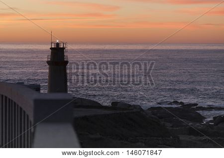 Spain Galicia Muxia Lighthouse at dusk ocean in the background