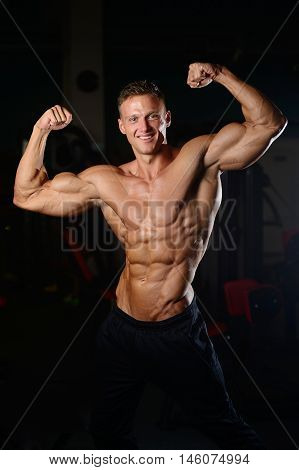 Handsome Muscular Bodybuilder Man Doing Exercises In Gym