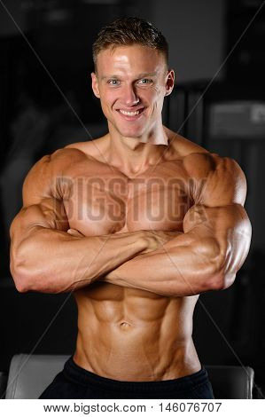 Handsome Muscular Bodybuilder Man Doing Exercises In Gym