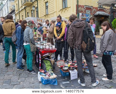 Kiev Ukraine - August 24 2016: Youth sells pottery on the street St. Andrew's descent - the historical center of Kiev