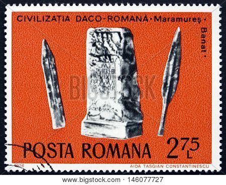 ROMANIA - CIRCA 1976: a stamp printed in Romania shows Sword Lance and Tombstone Daco-Roman Archaeological Treasure circa 1976