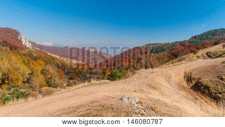 Autumnal landscape with earth road in mountain pasture Demerdzhi Crimean peninsula