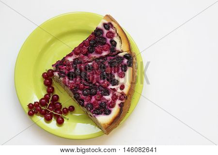 Pieces of berry pie with fresh red currants on a white background. Top view.