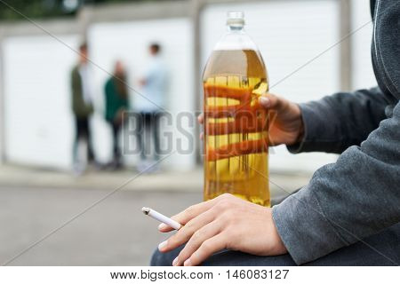 Close Up Of Teenager Drinking Alcohol And Smoking