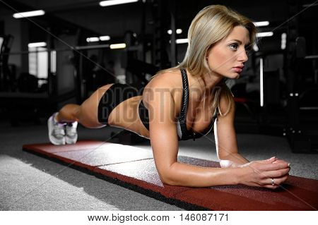 Beautiful Fitness Woman Trains In The Gym.