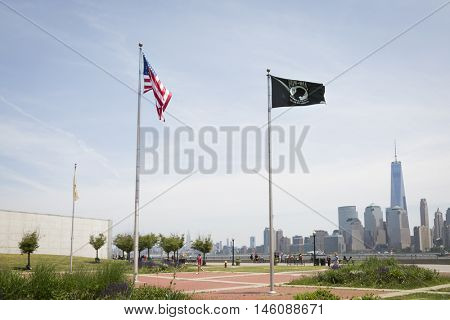 JERSEY CITY NJ MAY 29 2016: The American Flag and POW/MIA Flag at Liberty State Park with the New York City skyline in the background seen during Fleet Week 2016.