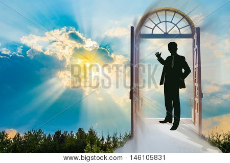 Beautiful sky background at sunset, with a man in a doorway, making the invitation gesture towards a brighter future