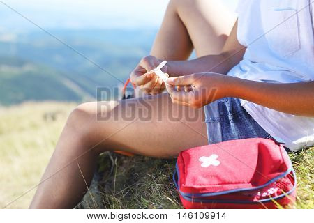 First aid kit, sticking plaster on knee