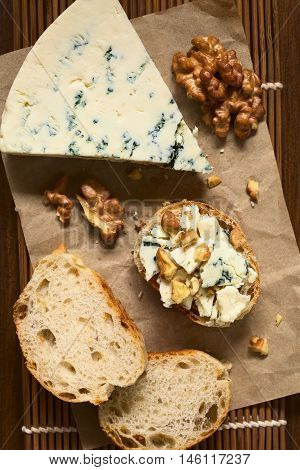 Blue cheese and walnut canape photographed overhead with natural light (Selective Focus Focus on the top of the canape and the blue cheese slice)