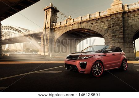 Moscow, Russia - August 06, 2016: Car Land Rover Range Rover Evoque standing on asphalt road in city Moscow at sunset