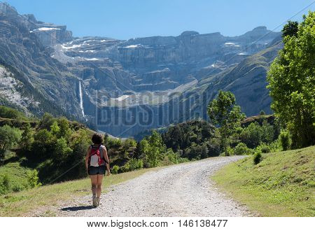 A woman hiker and cirque de Gavarnie in the French pyrenees