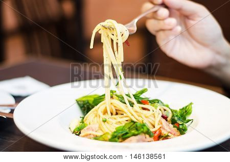 The spaghetti mixed with stir-fried spicy fish. Aromatic spices taste