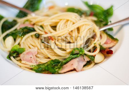 The spaghetti mixed with stir-fried spicy fish. Aromatic spices taste