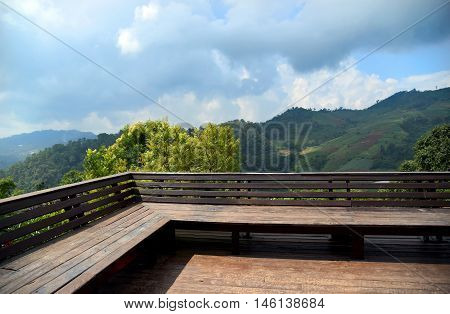 Wood balcony with mountain landscape view at Mae Cham, Chiang Mai, north of Thailand.