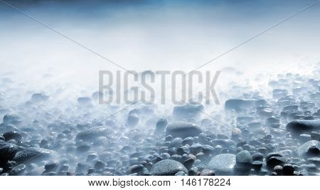 Background of water and rolling stones at Moelen