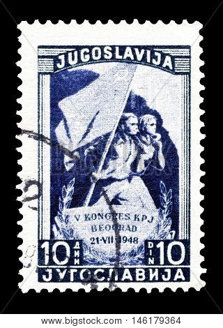 YUGOSLAVIA - CIRCA 1948 : Cancelled postage stamp printed by Yugoslavia, that shows Marchers with party flag.