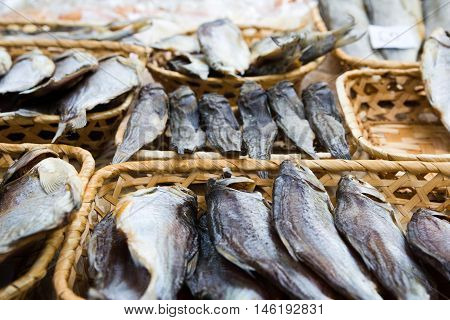 Different kinds of dried fish in the store in baskets at beer fesival