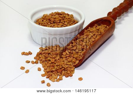 organic fenugreek seeds isolated on white background