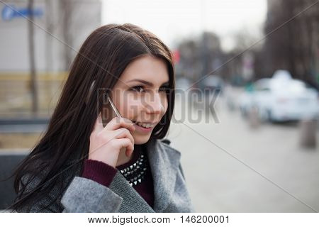 Young Pretty Brunette Girl Talking On The Phone