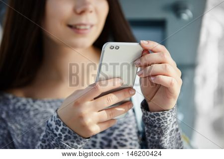 Cute White Girl Using Modern Dual Camera Smart Phone