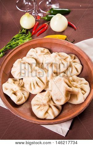 hot fresh georgian food,hinkali with parsley in restaurant