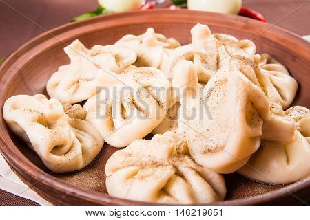 hot fresh georgian food,hinkali with parsley in restaurant