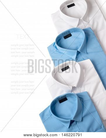 A row of white and blue male shirts isolated on white background closeup